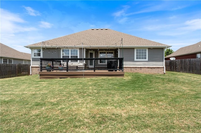 rear view of house featuring a deck and brick siding