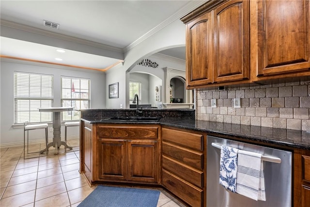 kitchen with a sink, backsplash, dark stone counters, dishwasher, and ornamental molding