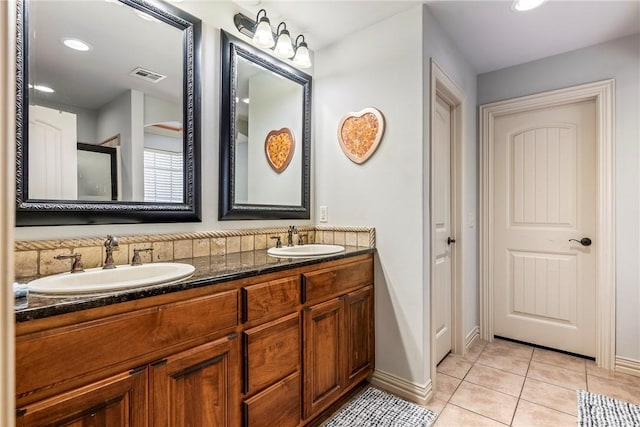 full bath with tile patterned flooring, double vanity, baseboards, and recessed lighting