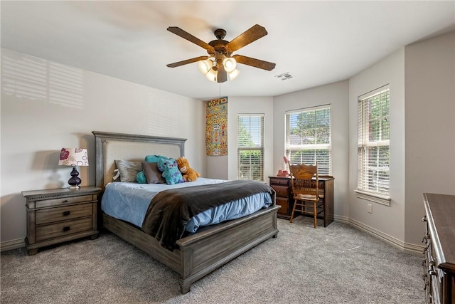bedroom with light carpet, baseboards, and a ceiling fan