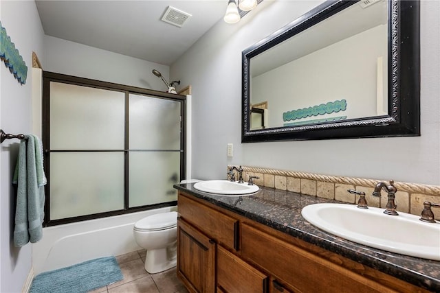 full bathroom with toilet, enclosed tub / shower combo, tile patterned floors, and double vanity