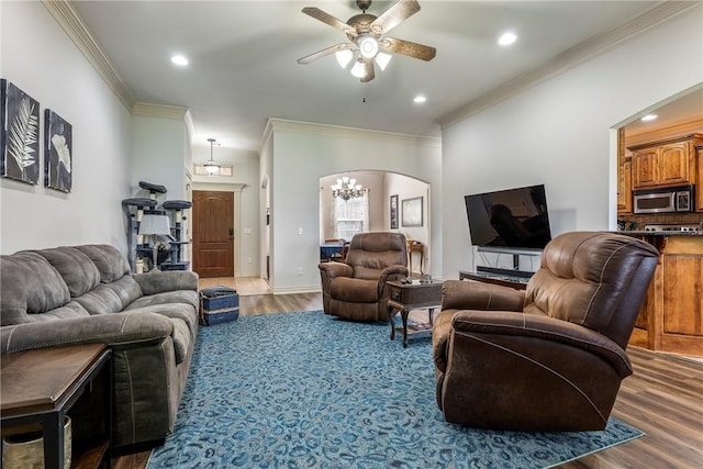 living room with crown molding, arched walkways, ceiling fan, wood finished floors, and recessed lighting