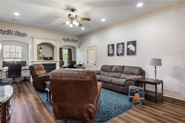 living area featuring arched walkways, an office area, a ceiling fan, dark wood finished floors, and crown molding