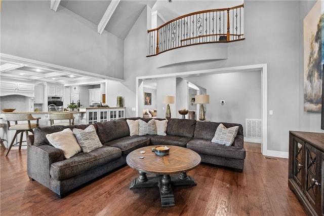 living room with beam ceiling, baseboards, wood finished floors, and high vaulted ceiling