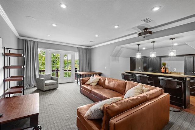 living area with recessed lighting, dark carpet, ornamental molding, and french doors