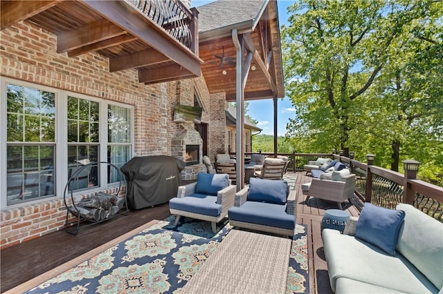 view of patio / terrace with an outdoor living space with a fireplace, grilling area, and a deck