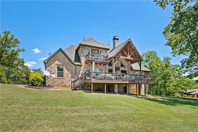 rear view of house featuring a chimney, a wooden deck, brick siding, a balcony, and stairs