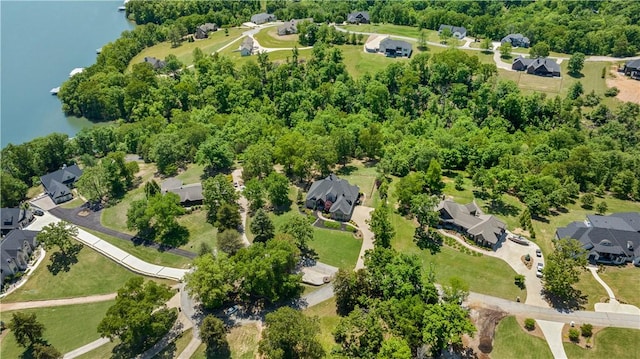 aerial view of property and surrounding area featuring a nearby body of water and nearby suburban area