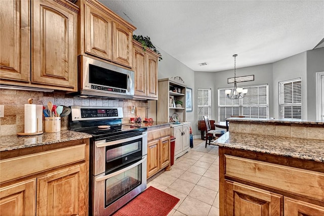 6201 S 36th St, Rogers, AR 72758 - kitchen featuring stainless steel appliances, tasteful backsplash, stone countertops, a chandelier, and light tile patterned floors