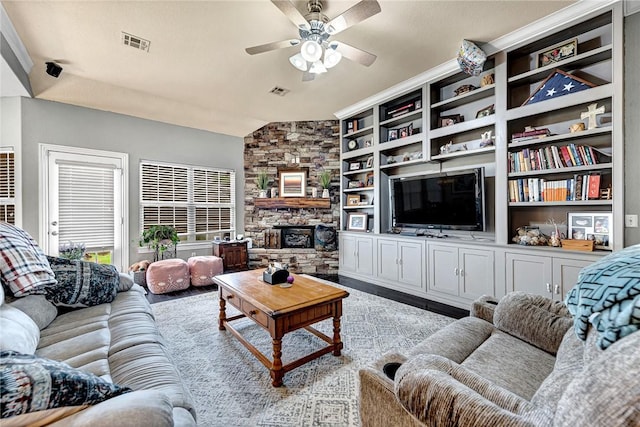 6201 S 36th St, Rogers, AR 72758 - living room with a ceiling fan, a stone fireplace, and wood finished floors
