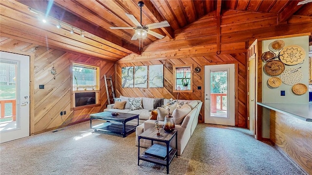 carpeted living room featuring wooden ceiling, wooden walls, and ceiling fan