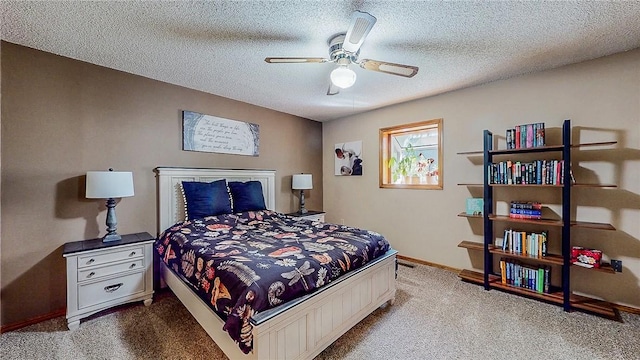 bedroom featuring carpet floors, a textured ceiling, baseboards, and a ceiling fan