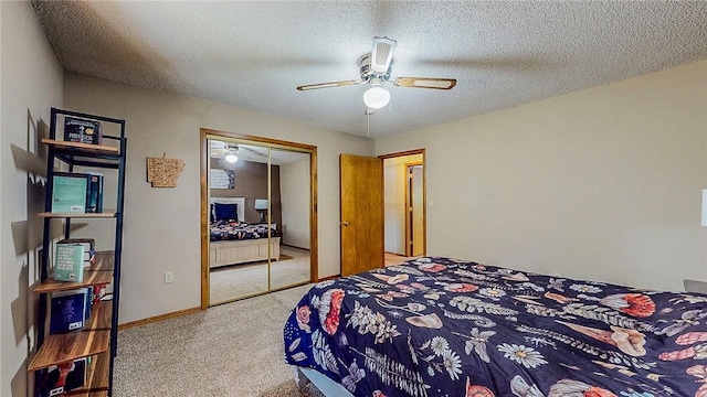 bedroom with carpet floors, a closet, a ceiling fan, and a textured ceiling