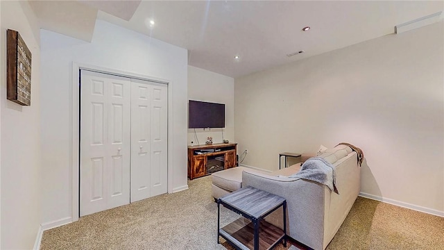 carpeted living room with recessed lighting and baseboards