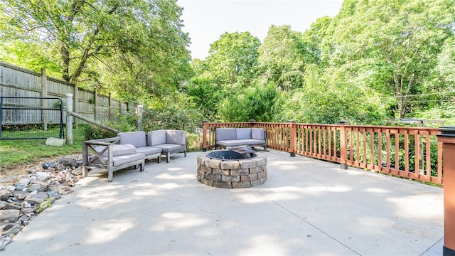 view of patio / terrace with an outdoor living space with a fire pit and a fenced backyard