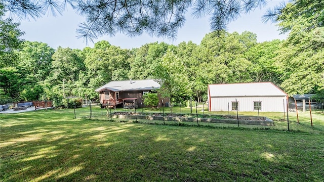 view of yard featuring a deck, an outbuilding, an outdoor structure, and a wooded view
