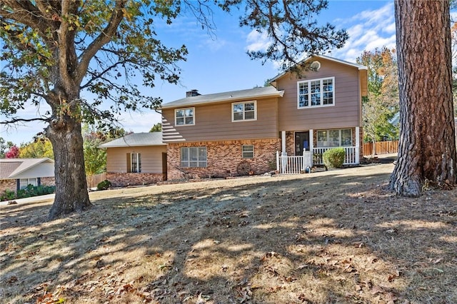 206 Suttle Dr, Springdale, AR 72764 - view of front of house featuring brick siding and a chimney
