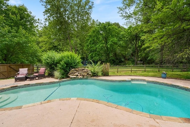 view of pool featuring a fenced backyard and a patio area