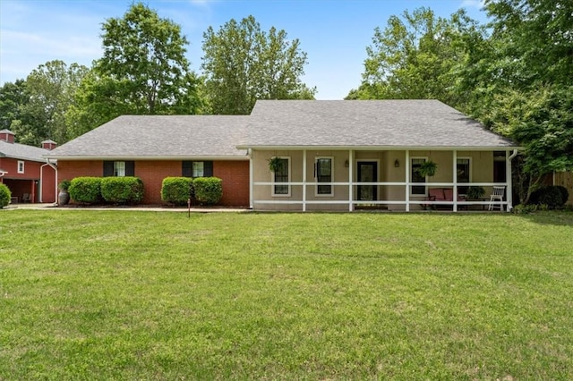 ranch-style house featuring a front yard and a shingled roof