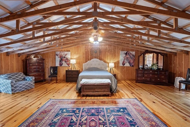 bedroom with hardwood / wood-style floors, lofted ceiling, and wooden walls