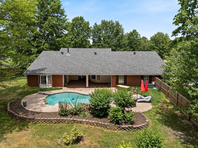 view of pool featuring a patio and view of scattered trees