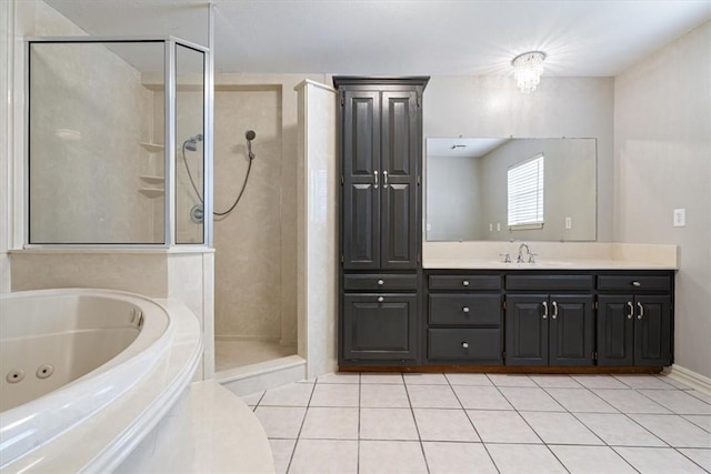 bathroom with a stall shower, tile patterned flooring, a whirlpool tub, and vanity