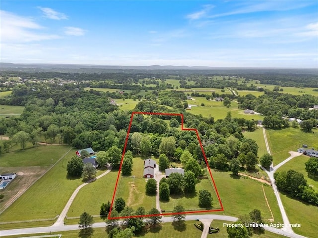 aerial view of property and surrounding area featuring property parcel outlined