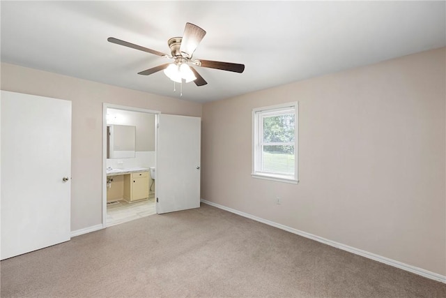 208 Date St, Russellville, AR 72802 - unfurnished bedroom with light colored carpet, baseboards, ensuite bath, and a ceiling fan