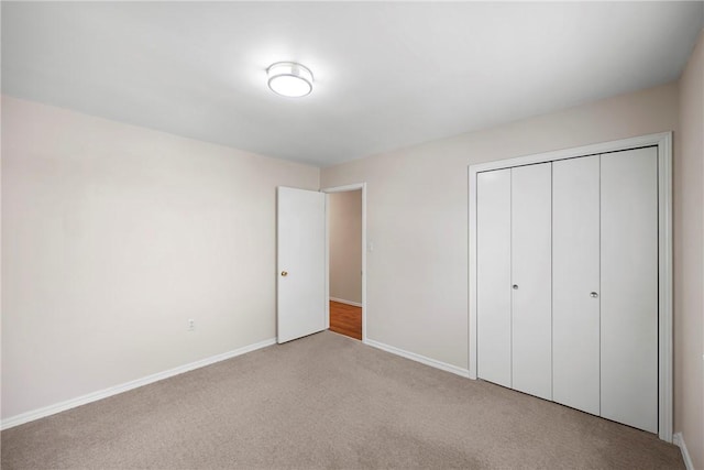 208 Date St, Russellville, AR 72802 - unfurnished bedroom with carpet floors, baseboards, and a closet