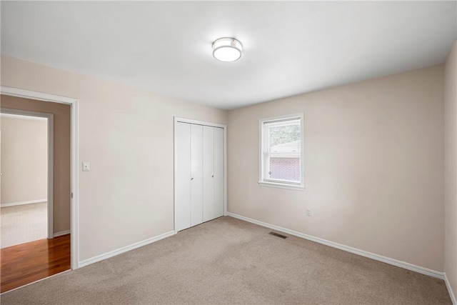 208 Date St, Russellville, AR 72802 - unfurnished bedroom with a closet, carpet floors, and baseboards