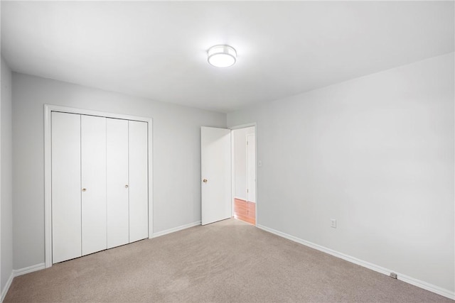 208 Date St, Russellville, AR 72802 - unfurnished bedroom with carpet, baseboards, and a closet