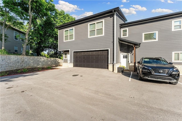 293 W Ash St Unit 1, Fayetteville, AR 72703 - view of front of home featuring a garage, brick siding, and driveway