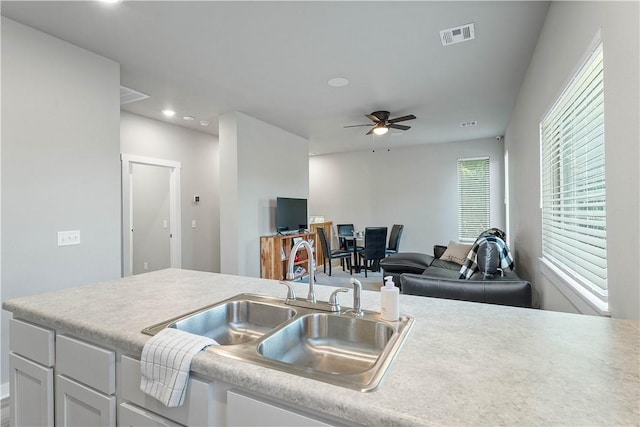 293 W Ash St Unit 1, Fayetteville, AR 72703 - kitchen featuring a sink, ceiling fan, white cabinets, light countertops, and recessed lighting