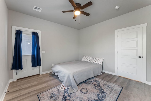 293 W Ash St Unit 1, Fayetteville, AR 72703 - bedroom with wood finished floors, baseboards, and ceiling fan