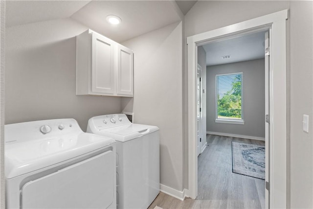 293 W Ash St Unit 1, Fayetteville, AR 72703 - clothes washing area with cabinet space, independent washer and dryer, light wood-type flooring, and baseboards