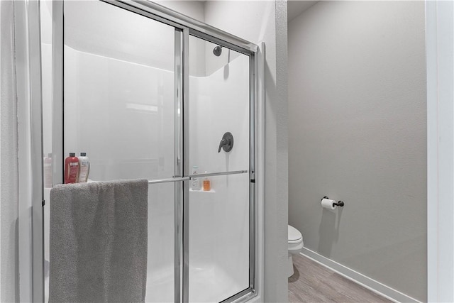 293 W Ash St Unit 1, Fayetteville, AR 72703 - full bathroom with baseboards, toilet, wood finished floors, and a shower stall