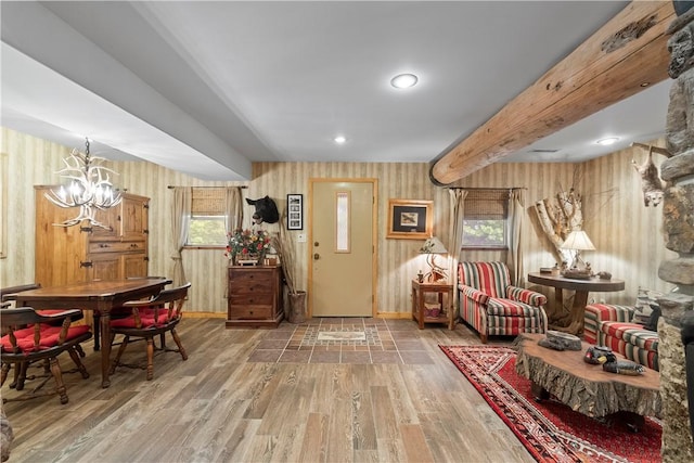 21432 Lakeview Dr, Garfield, AR 72732 - interior space with wood finished floors, a chandelier, wallpapered walls, and baseboards