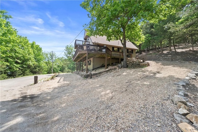 21432 Lakeview Dr, Garfield, AR 72732 - rear view of house featuring a wooden deck and driveway
