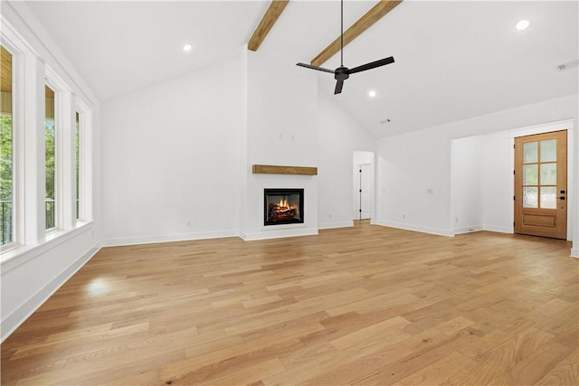17 Winters Dr, Bella Vista, AR 72714 - unfurnished living room with ceiling fan, beam ceiling, high vaulted ceiling, a glass covered fireplace, and light wood-type flooring