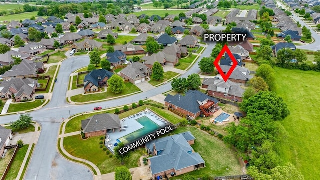 aerial overview of property's location with nearby suburban area and a pool