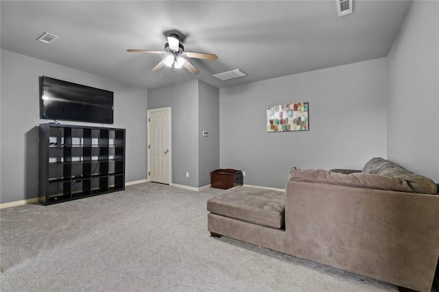 living room featuring ceiling fan, carpet, and baseboards