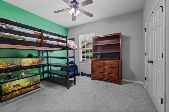 carpeted bedroom with a closet and ceiling fan