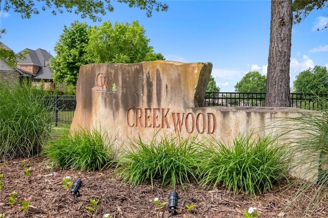 community sign featuring fence