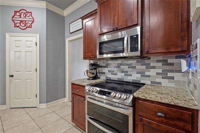 kitchen featuring appliances with stainless steel finishes, ornamental molding, backsplash, light tile patterned floors, and light stone counters
