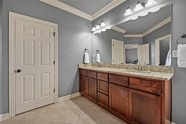 bathroom featuring crown molding, double vanity, baseboards, and tile patterned floors