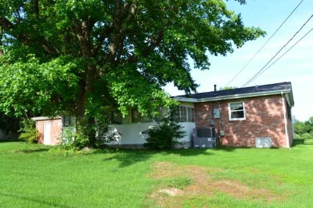 420 Natchez Trace Dr, Harrison, AR 72601 - back of house with brick siding and a yard