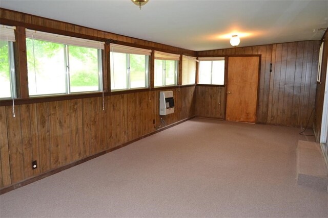 420 Natchez Trace Dr, Harrison, AR 72601 - unfurnished room featuring wooden walls, heating unit, and light colored carpet