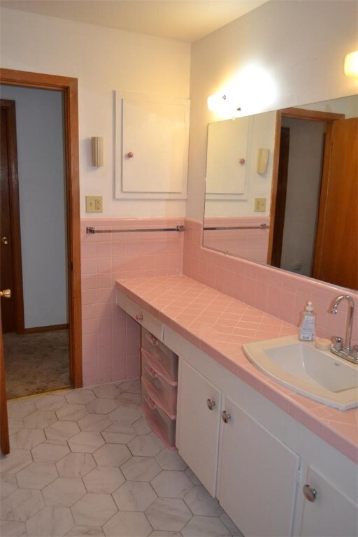 420 Natchez Trace Dr, Harrison, AR 72601 - bathroom featuring vanity, a wainscoted wall, tile walls, and tile patterned floors