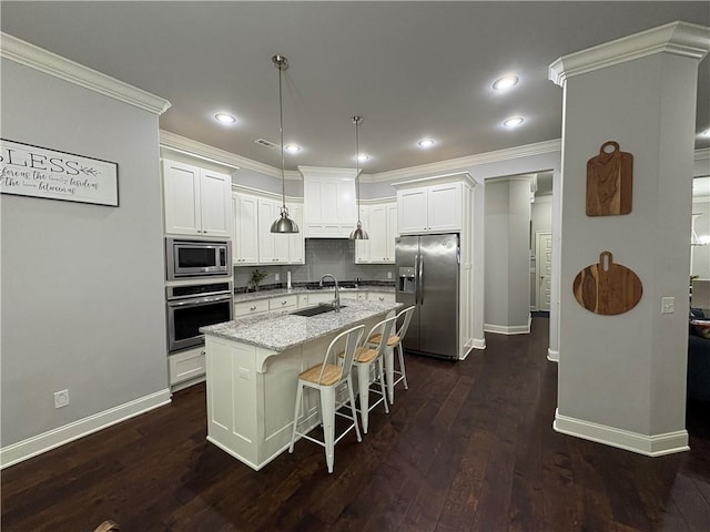 773 Via Firenze Ave, Tontitown, AR 72762 - kitchen featuring appliances with stainless steel finishes, baseboards, white cabinets, an island with sink, and dark wood-style flooring