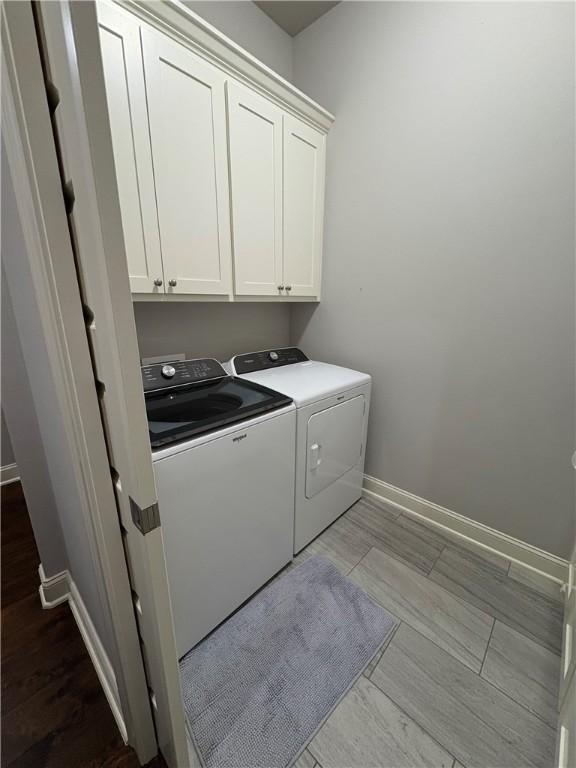 773 Via Firenze Ave, Tontitown, AR 72762 - laundry room featuring washer and dryer, cabinet space, baseboards, and wood finished floors